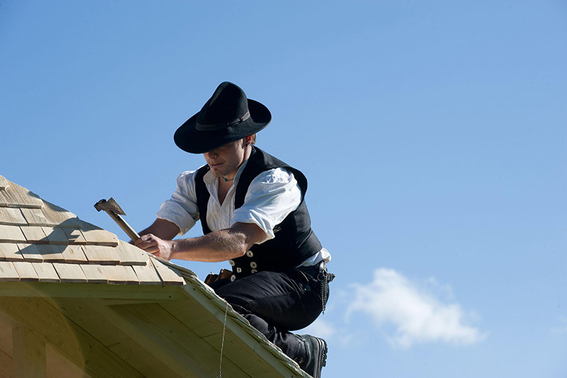Man mending roof
